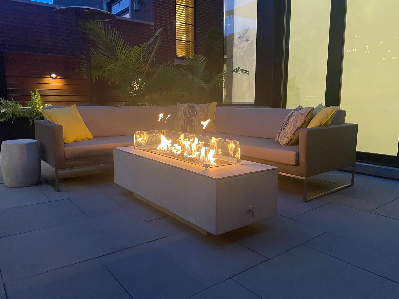 Completed Chicago courtyard with a glowing fire feature and outdoor seating, designed by Beautyberry Designs